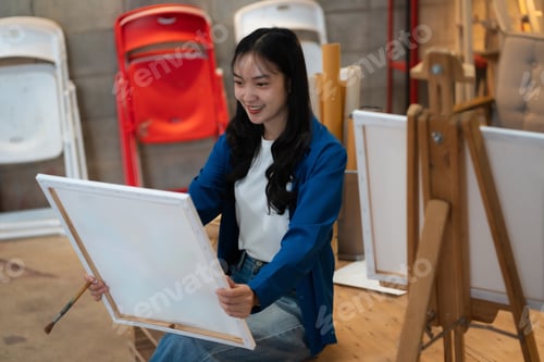 Preview: Artistic young woman working on a new painting.