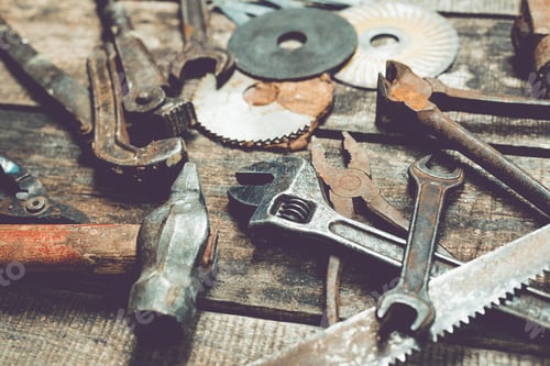 Preview: Collection of vintage tools arranged on a rustic wooden surface highlighting craftsmanship and