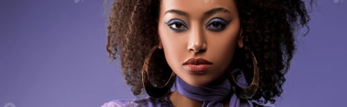 Preview: panoramic shot of attractive african american woman with earrings looking at camera isolated on