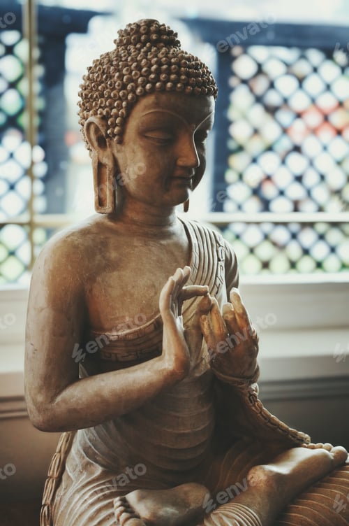 Preview: Ornate sculpture of a buddha figure near a window