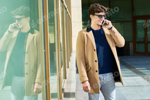 Preview: Young Man Speaking by Phone Outdoors