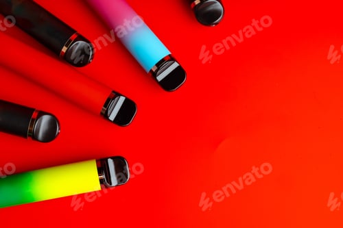 Preview: Colorful disposable electronic cigarettes on red background