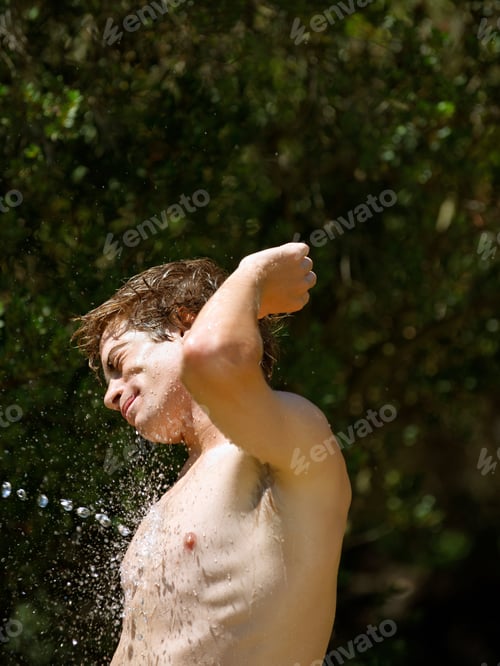 Preview: Young man being sprayed with water
