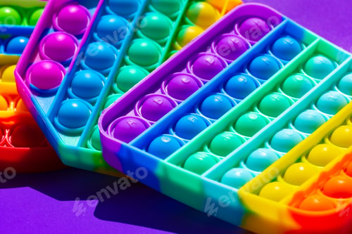 Preview: Colorful antistress pop it toy on purple background