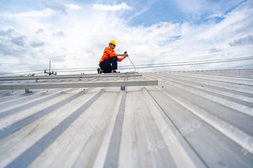 Preview: skilled technician adjusts a solar panel on rooftop
