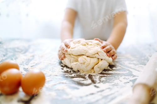 Preview: Small hands kneading dough. Little child preparing dough for backing. Kid's hands, some flour.