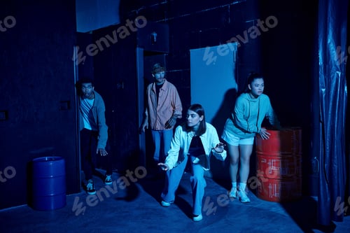 Preview: group of multicultural young people engaged in thrilling escape room challenge, indoor adventure