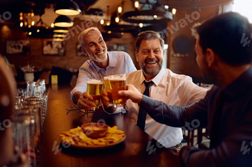Preview: Cheerful businessmen toasting while gathering for a beer in a pub.