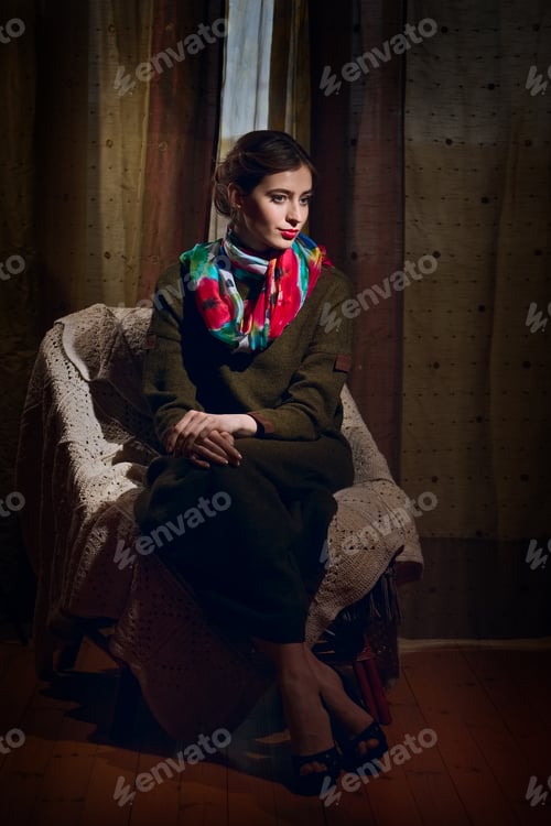 Preview: Portrait of woman sitting in armchair and looking at someting