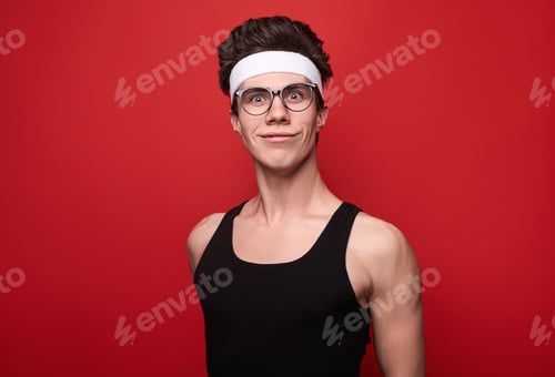 Preview: Funny man in glasses and sportswear looking at camera