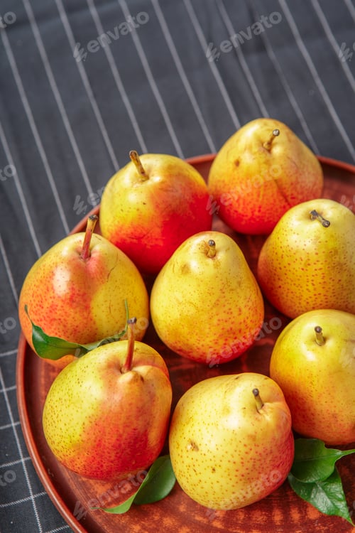 Preview: organic pears laying down on a lightly dotted kitchen cloth