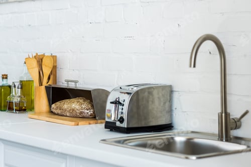 Preview: toaster, breadbasket with bread near sink in kitchen