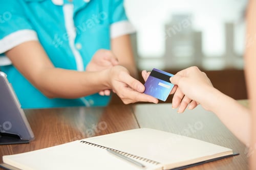 Preview: Guest giving card to spa salon administrator