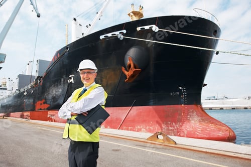Preview: A happy foreman standing with his arms crossed in front of a ship.