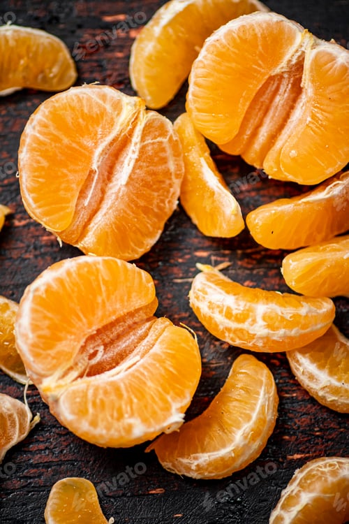 Preview: Peeled tangerines. Against a dark background.