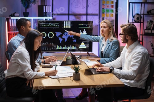 Preview: Multiracial partners discussing financial project at office