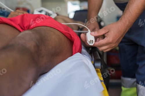 Preview: Paramedic preparing medical equipment for patient in ambulance