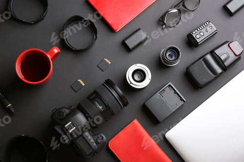 Preview: Flat lay composition with professional photographer equipment on dark background