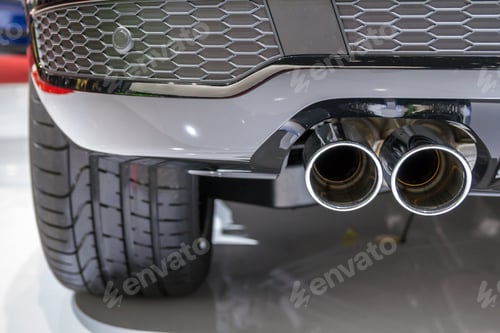 Preview: Double chrome exhaust pipe of powerful sport car with grey plastic details