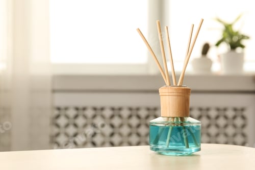 Preview: Reed air freshener on table indoors, space for text