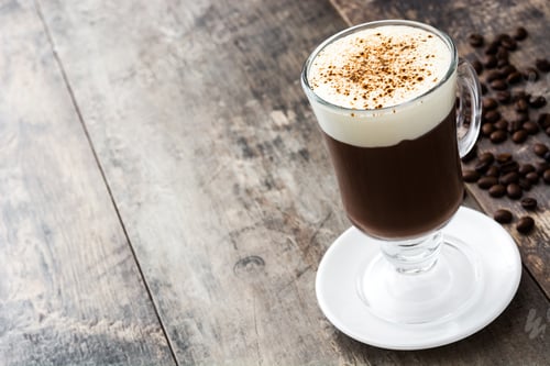 Preview: Irish coffee with whipped cream and coffee beans on rustic wood table