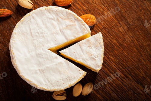 Preview: Camembert cheese or brie on wooden background.