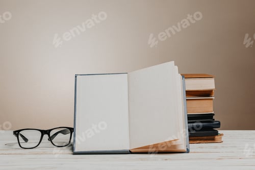 Preview: School blackboard with pile of books
