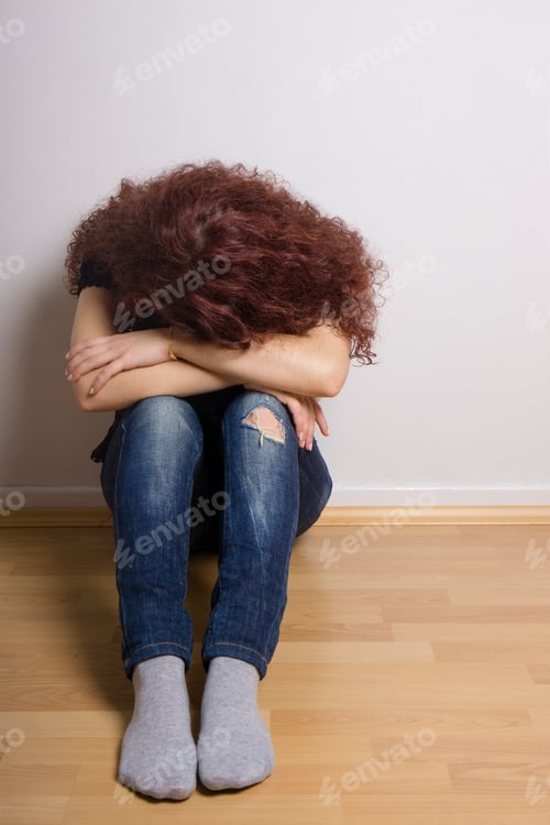 Preview: sad depressed young woman hiding her face