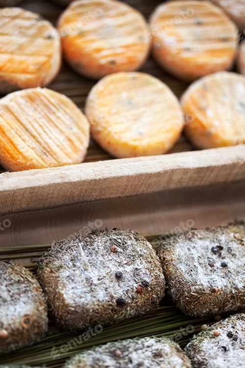 Preview: Close up of goat cheeses in crates