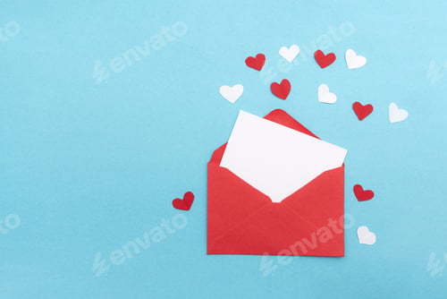 Preview: Red envelope with blank card and paper hearts for valentine's day invitation on blue background