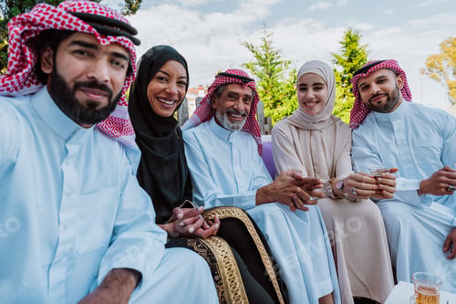 Preview: Middle eastern muslim family enjoying tea and togetherness outdoors