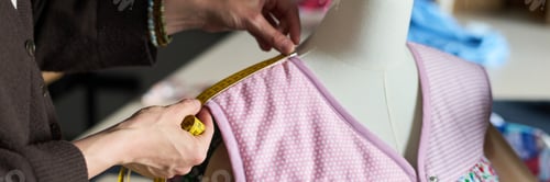 Preview: Caucasian Woman Measuring Shoulder of Mannequin While Sewing
