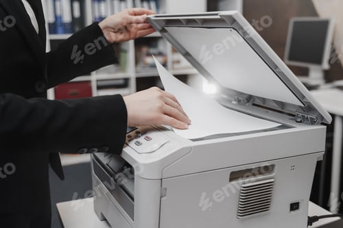 Preview: Business woman is using the printer to scanning