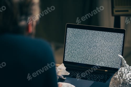 Preview: A paranoid man stares at a non-working laptop screen.