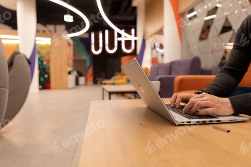 Preview: Modern office in open space style, man, programmer makes code