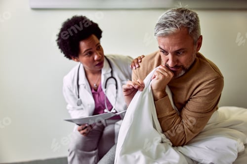 Preview: Caring African-American Doctor Comforting Anxious Patient in Medical Environment