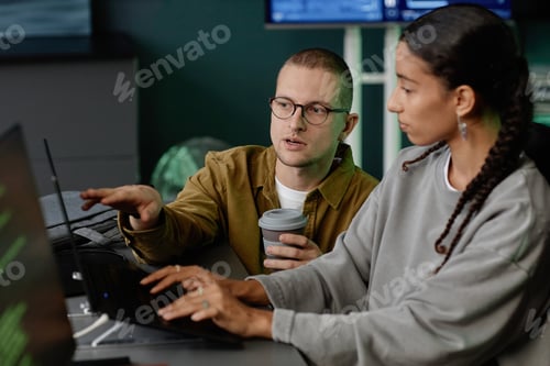 Preview: Portrait of Male IT Programmer Discussing with Female Colleague while Collaborating in Office