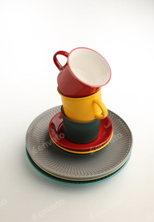 Preview: Beautiful multi-coloured bright ceramic bowl and tarenes on the table. Clean crockery concept