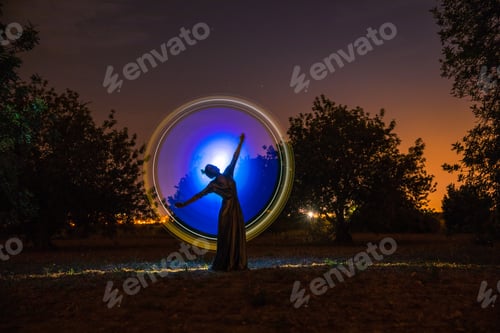 Preview: Female silhouette in glowing circle in nature