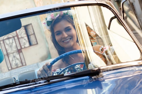 Preview: Beautiful woman driving a retro convertible car