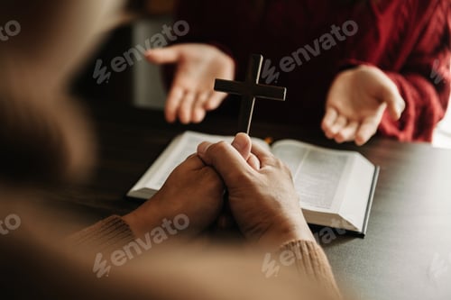Preview: Two people reading and study bible in home and pray together.Studying the Word Of God With Friends.