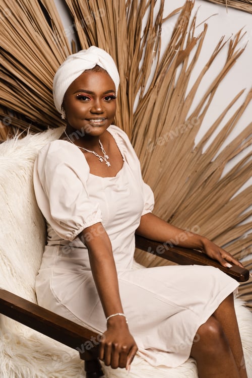 Preview: Studio portrait of black business lady on dry leaves background, posing confidently