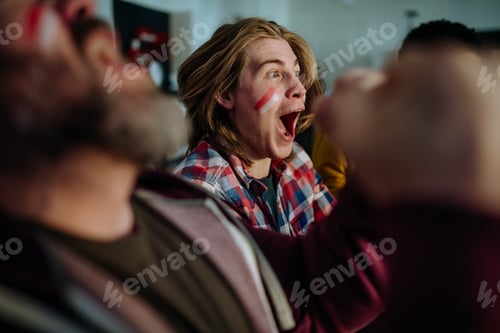 Preview: Happy Austrian football fans friends watching football at home and celebrating