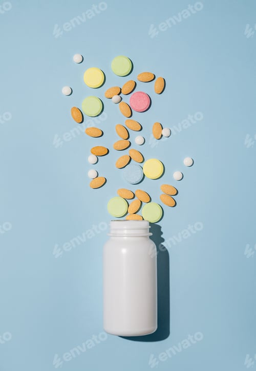 Preview: A variety of tablets and nutritional supplements of different colors are dynamically poured out