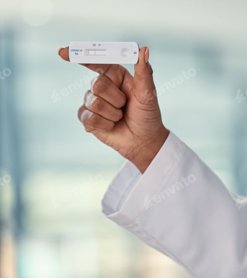 Preview: Hand of a doctor holding a negative covid test. African American doctor holding a corona virus test