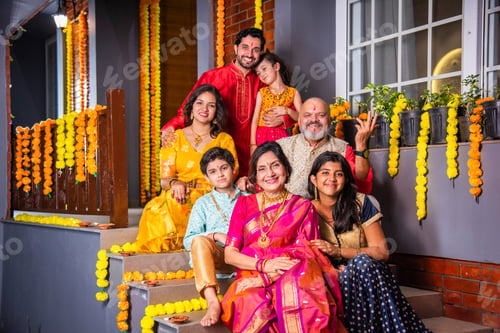 Preview: Indian family in traditional attire taking a group selfie on steps in Diwali or festival celebration