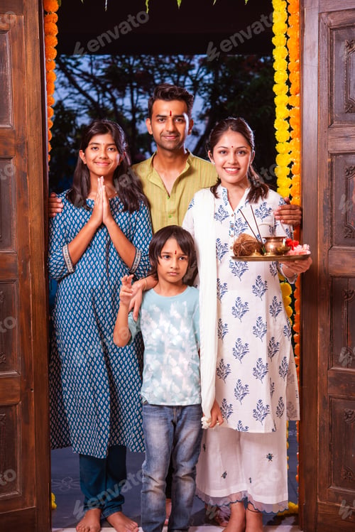 Preview: Gruhapravesh - indian asian family in traditional wear entering new home