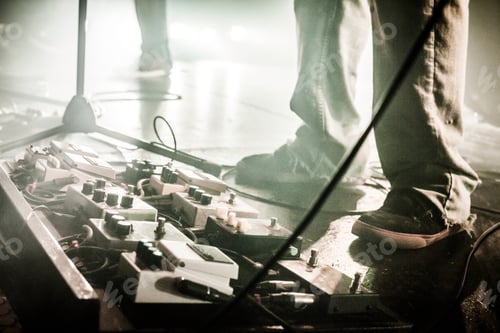Preview: Guitar Pedals on a stage with live band performing during a Show