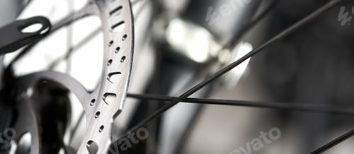 Preview: Bicycle disk brakes close up, metal disc attached to bike wheel, effective mountain bicycle brakes