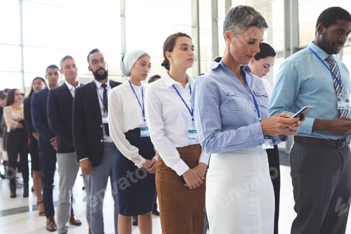Preview: Front view of diverse business people waiting in queue in lobby at office